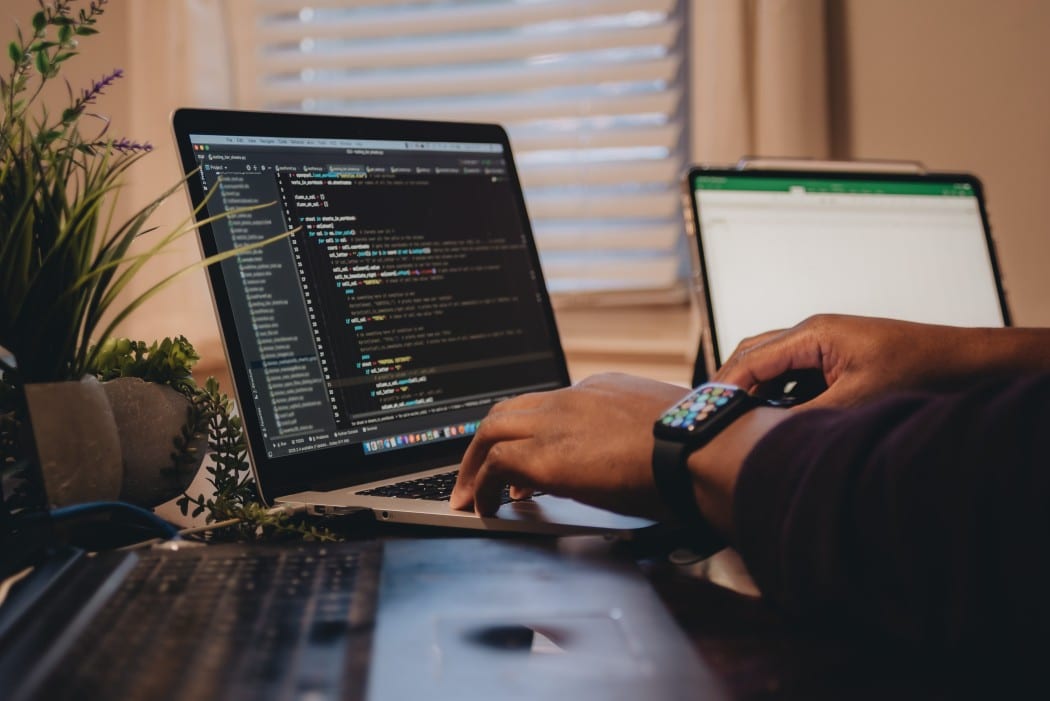 a person using a laptop for web programming and coding