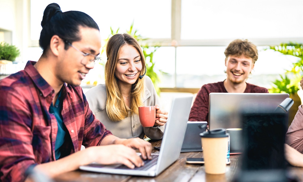 Entrepreneurs sharing content using a laptop.