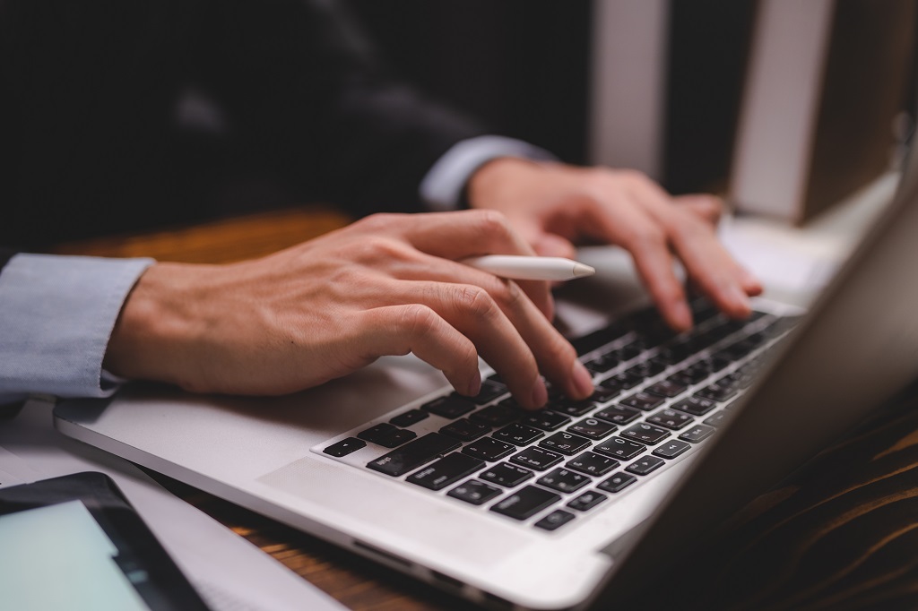 Businessman person using a computer & tablet for business communication