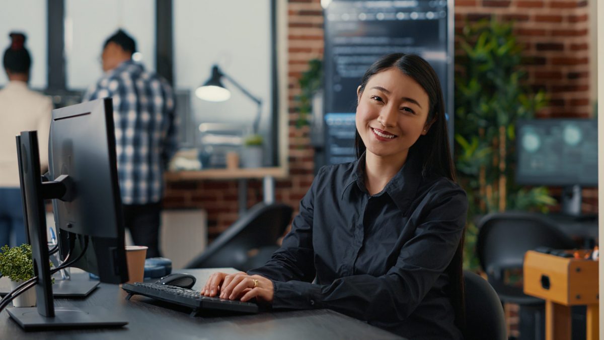 Asian female happy to become web developer.