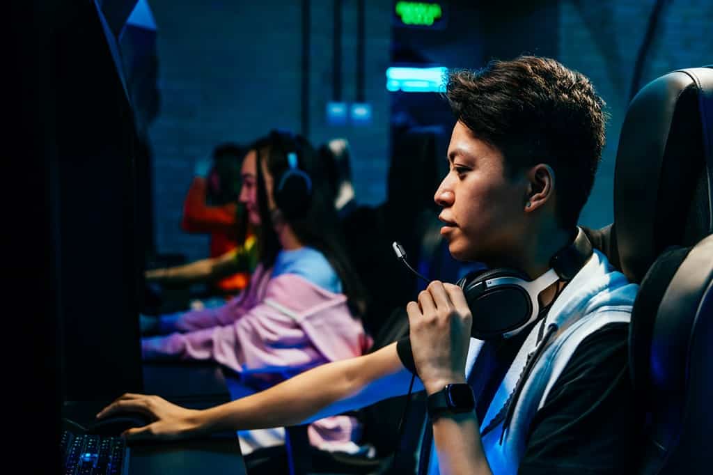 focused Filipino gamer with headphones