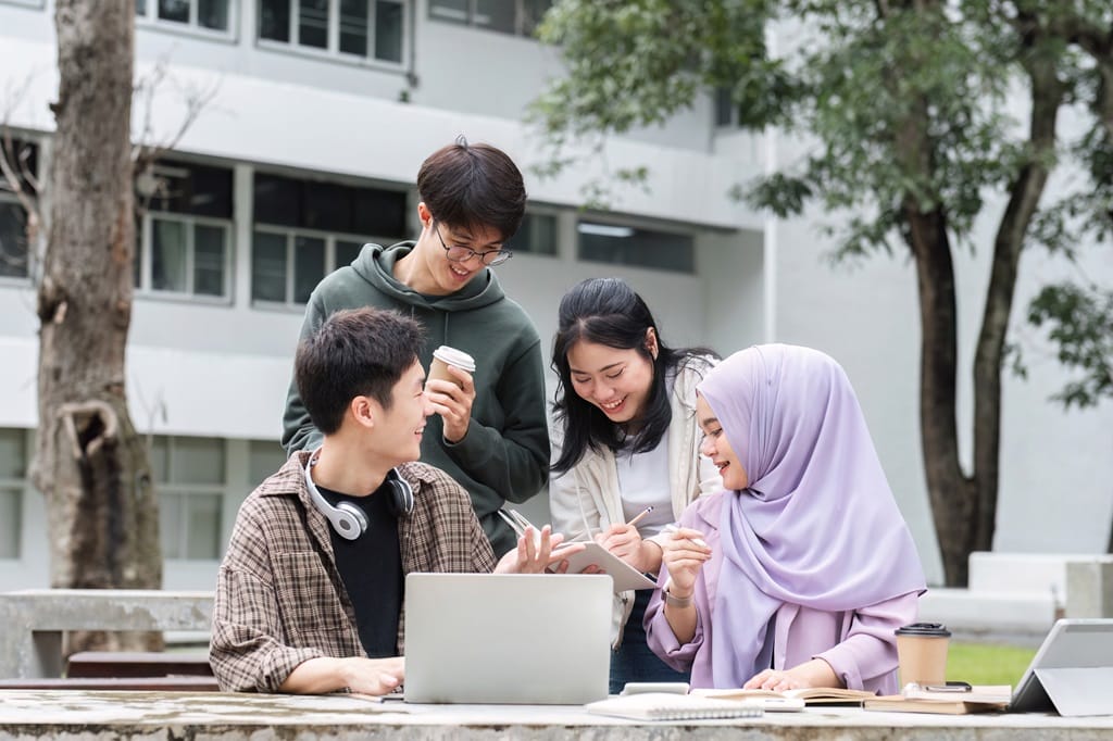 group of programming students discussing coding concepts