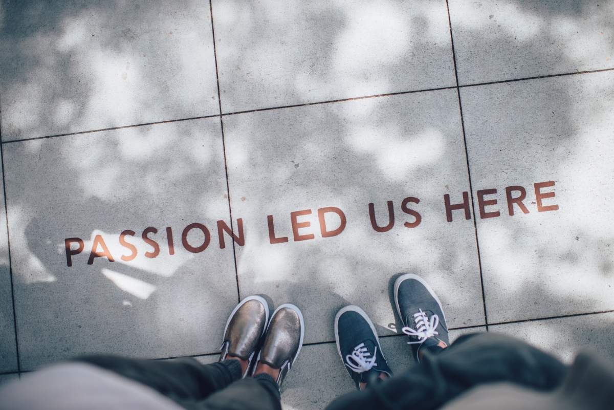 Two K12 track for animation students standing on a floor with the words “Passion led us here”