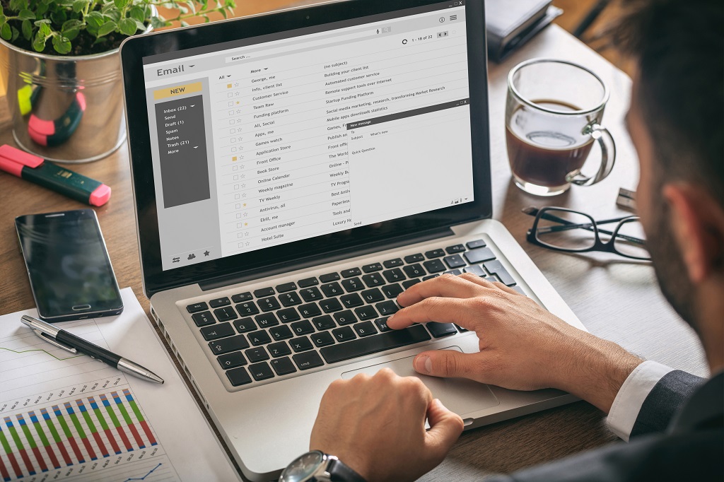 A man working email marketing on laptop