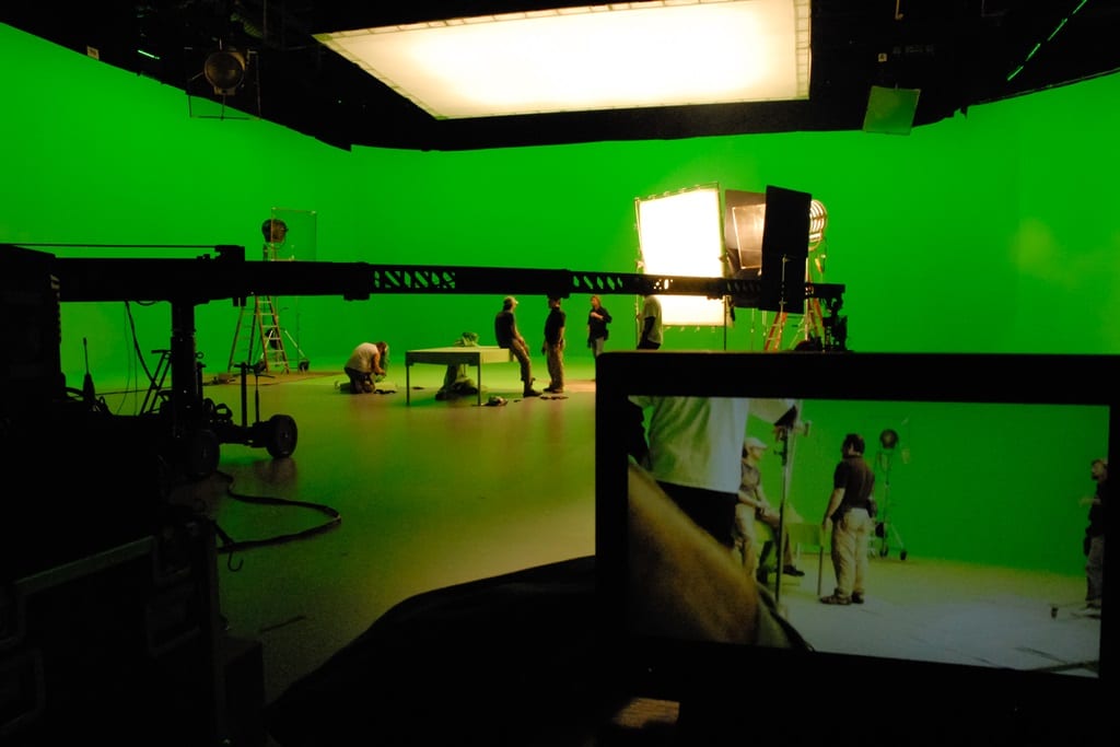 movie production setup featuring green screens for special effects