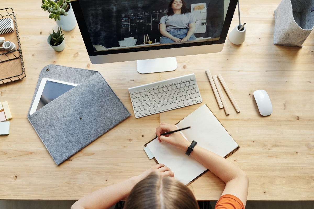 Student taking notes from online courses