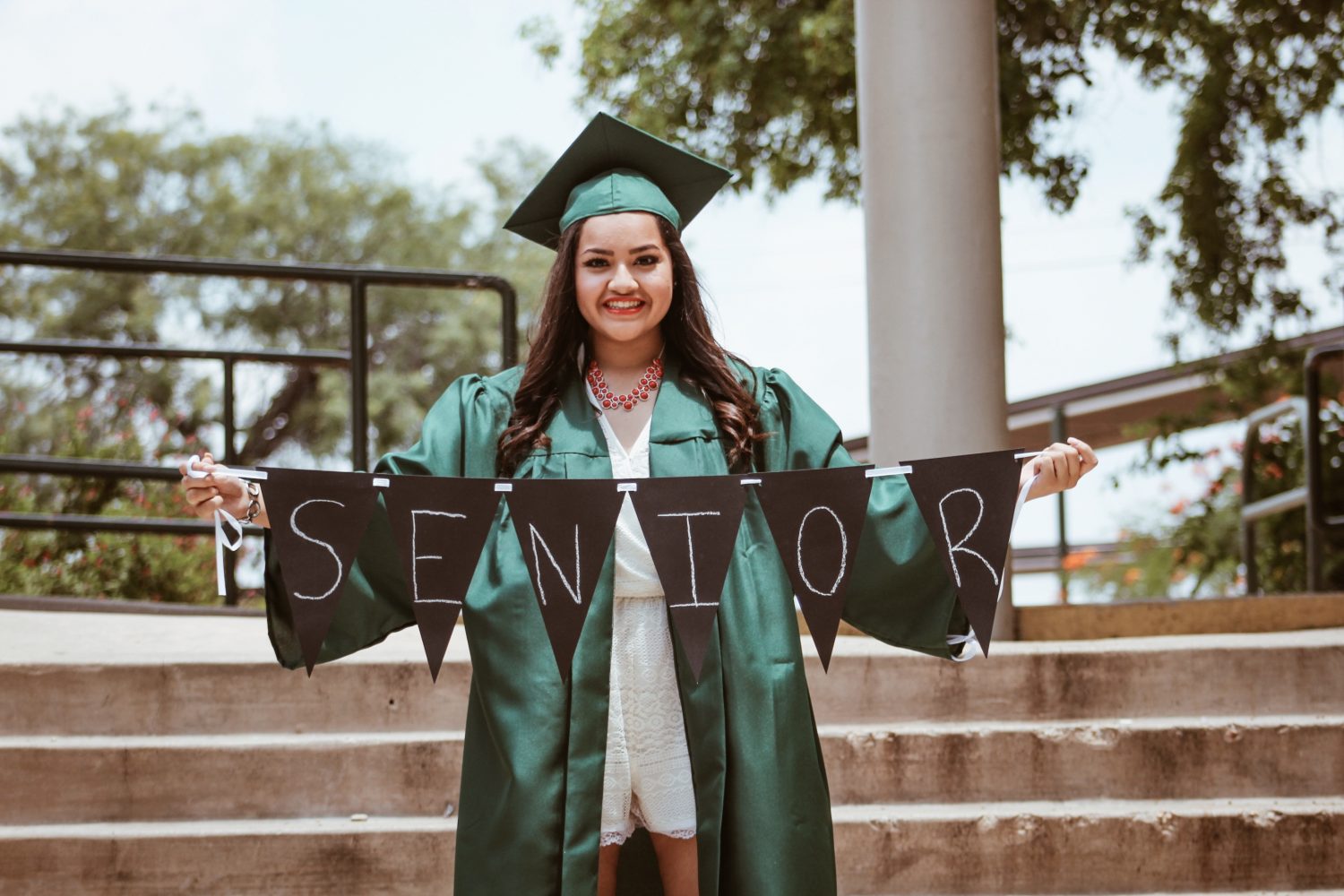 Senior High School student holding a banner for the Senior High School graduates