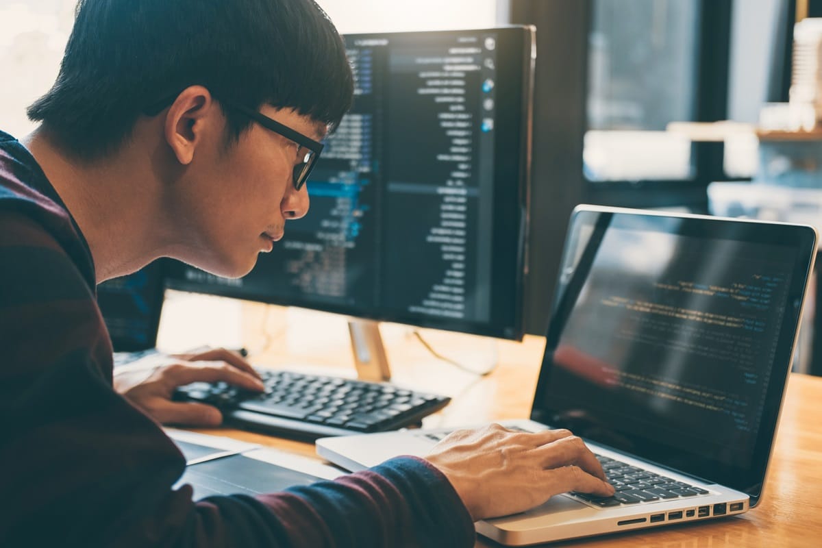 student coding various programming languages using a laptop