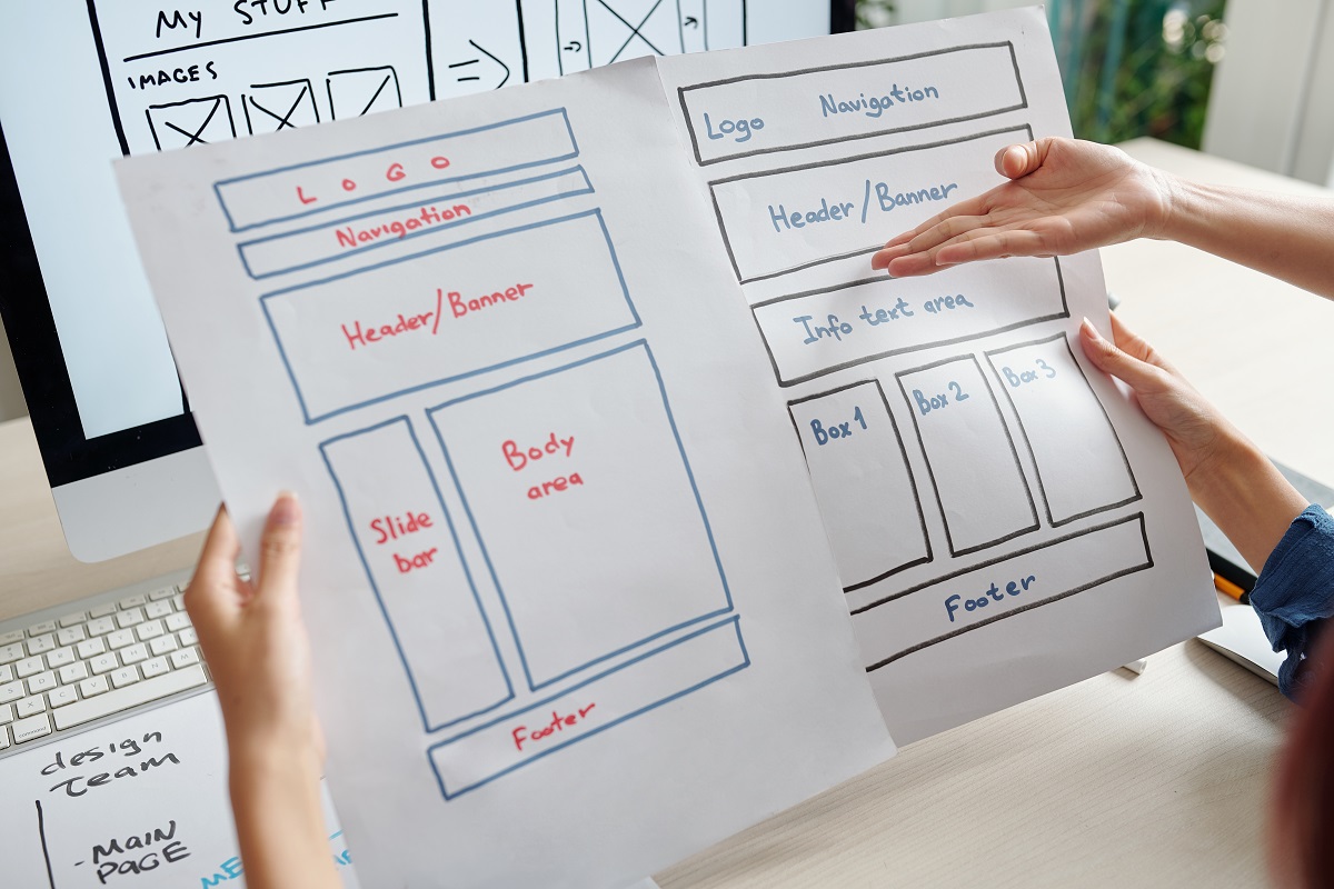 student designers analyzing a website layout on a computer screen