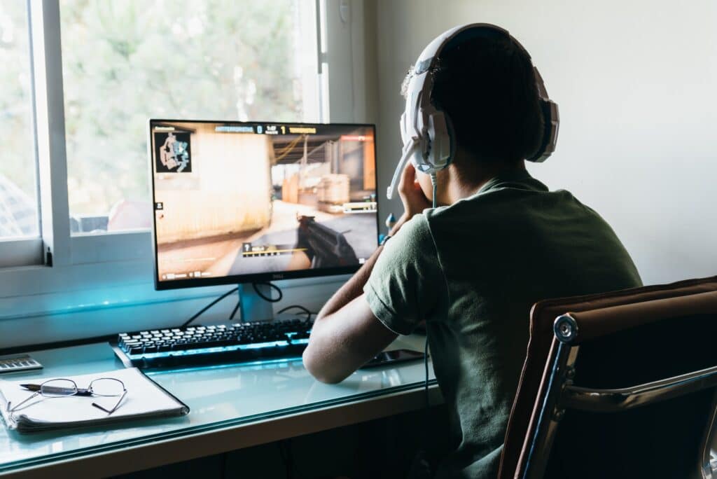 teen playing computer game on his PC