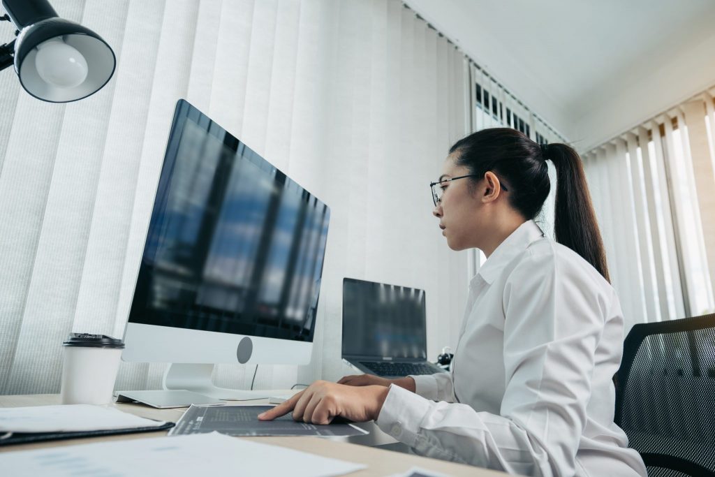 A woman showing how to become web developer working as back-end developer.