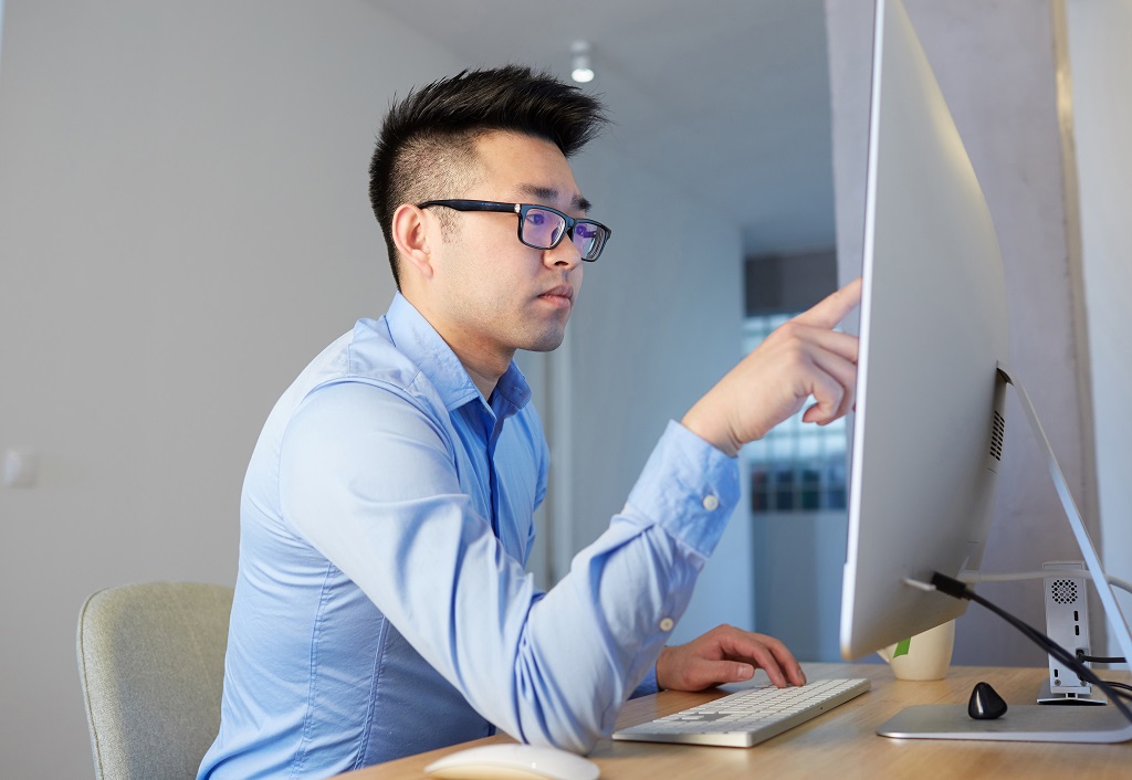 Young Asian man programmer wearing-shirt and glass importance of computer programming