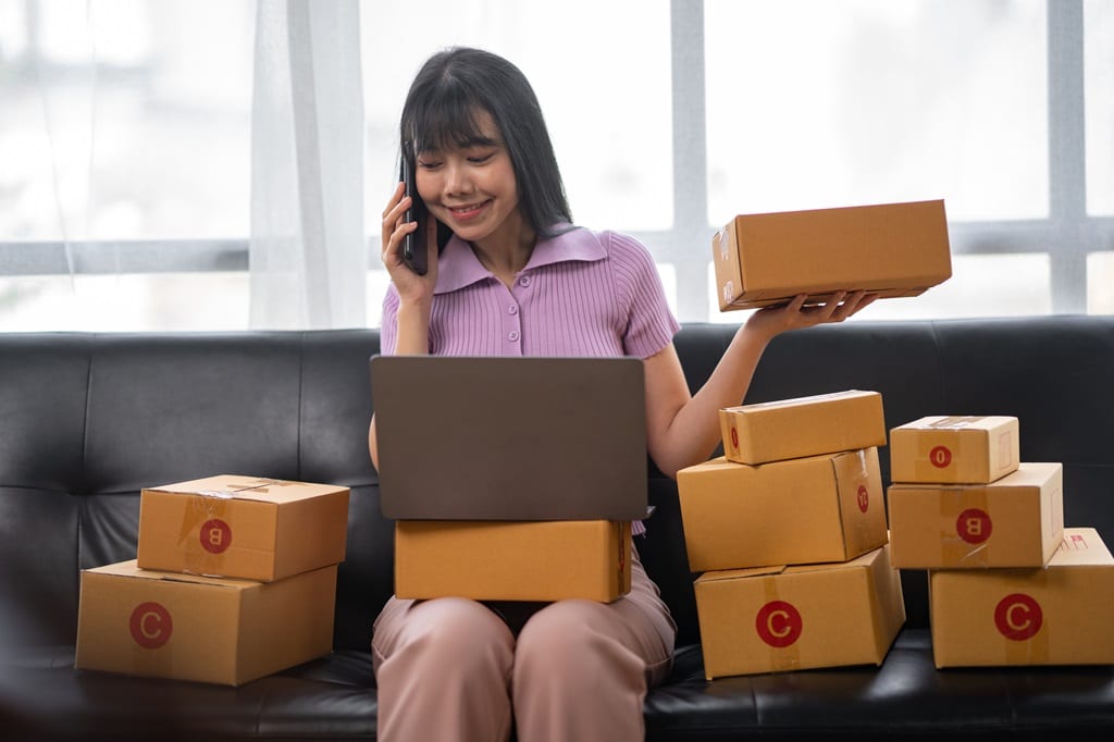 young entrepreneur managing her online business using her laptop